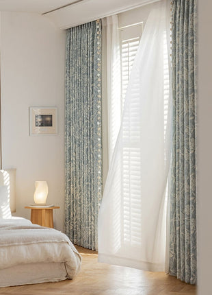 a bedroom with a white bed and blue curtains