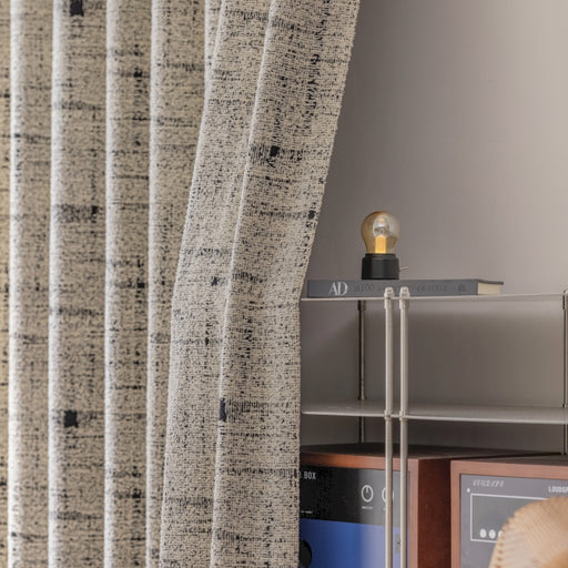 ein Zimmer mit einem Regal und einem Fenster mit einem Vorhang