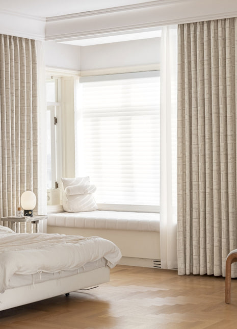 a bedroom with a white bed and a window