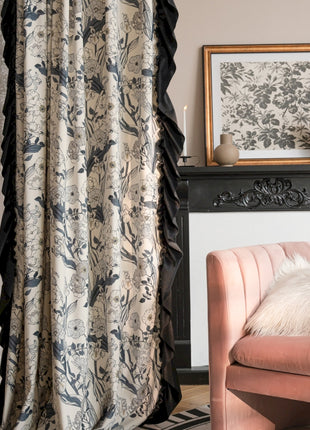 a living room with a pink chair and a black fireplace