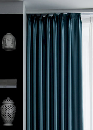 a white vase sitting on top of a shelf next to a window