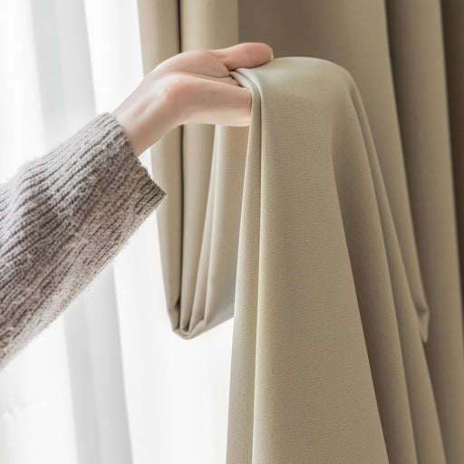 a person is holding a curtain in front of a window