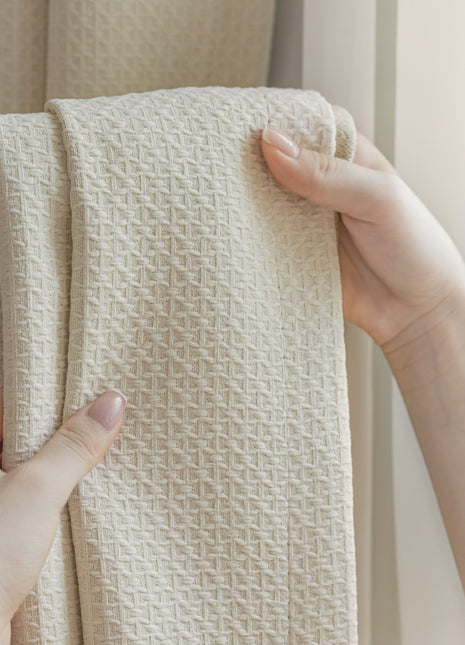 a person holding a white towel in front of a window
