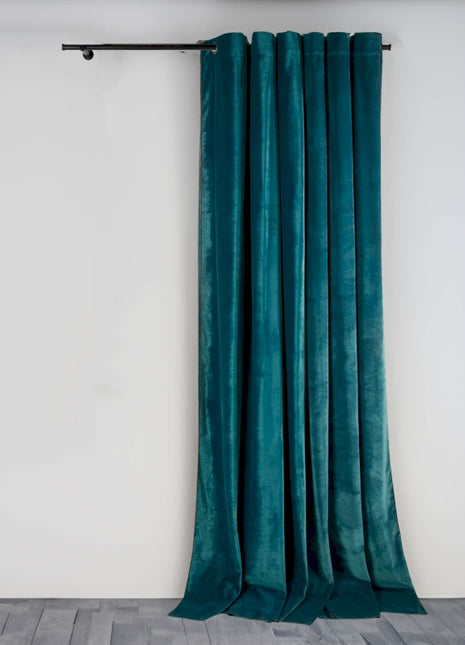 a green curtain hanging on a white wall