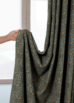a person is opening a curtain with their hand