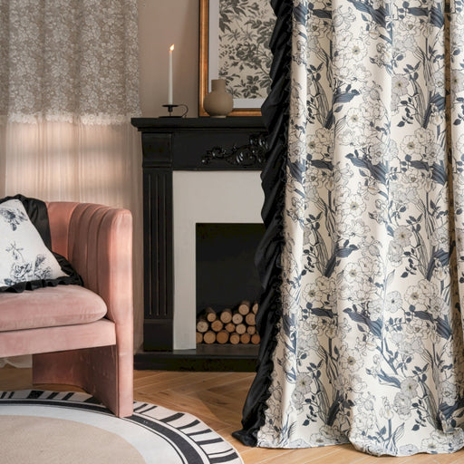 a living room with a pink chair and a fireplace