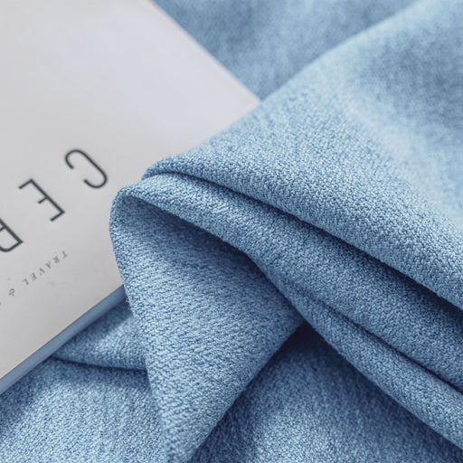 a close up of a blue blanket with a label on it