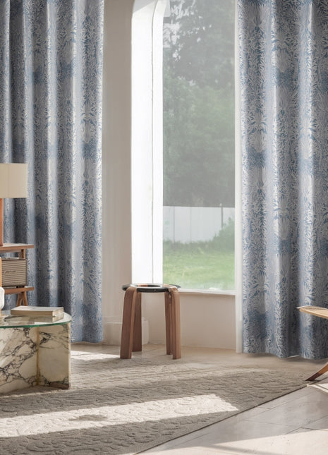 a living room with a chair and a window