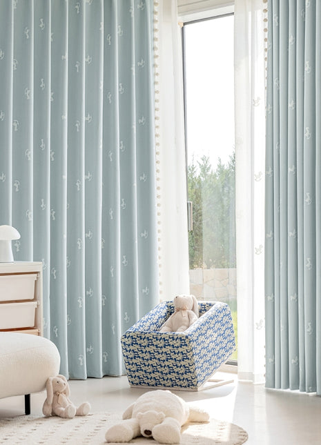 a baby's room with a blue and white theme