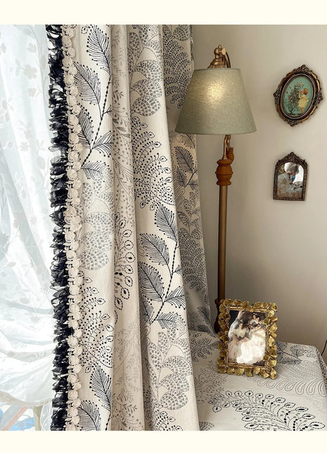 a lamp sitting on top of a table next to a window