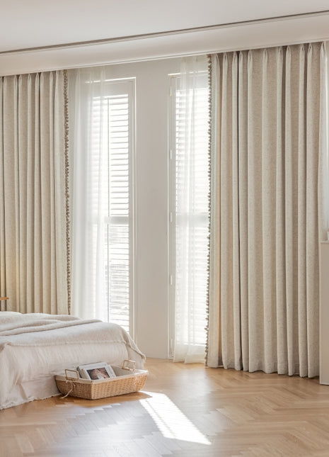 a bedroom with a bed and a large window