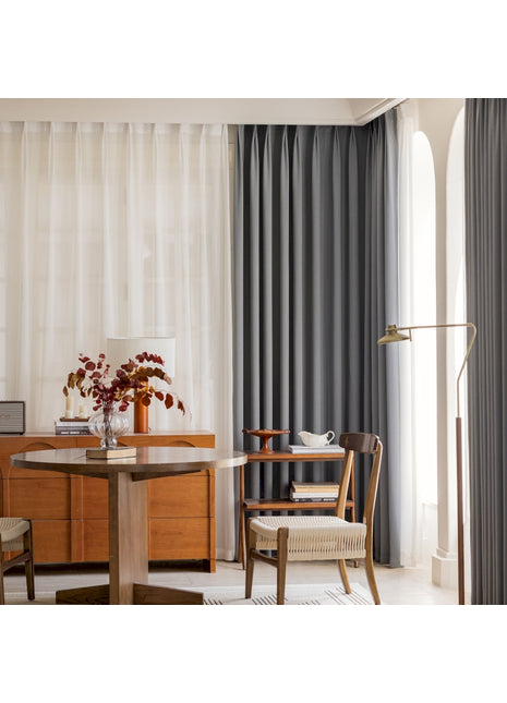 ein Wohnzimmer mit einem Tisch, einem Stuhl und einem Fenster