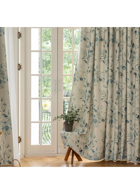 Ein Stuhl vor einem mit Vorhängen verhängten Fenster