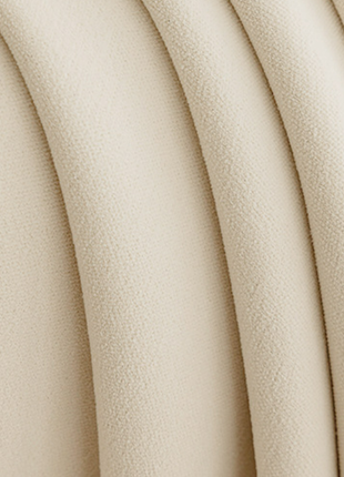 A close-up view of a fabric with a smooth, curved texture, possibly a piece of clothing or a textile.