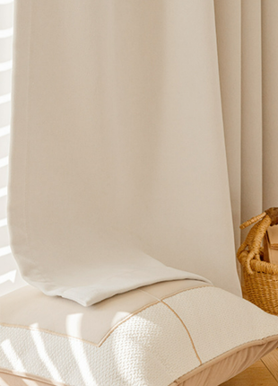 a cozy and inviting living space with a white pillow, a woven basket, and a book on a wooden floor.