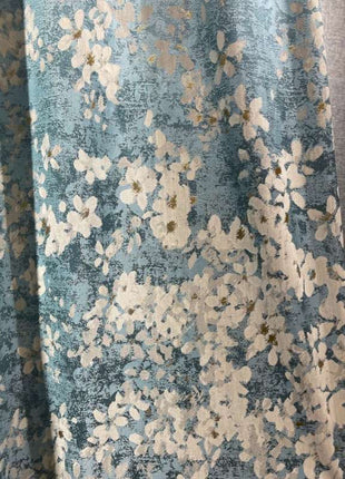 a close up of a curtain with flowers on it