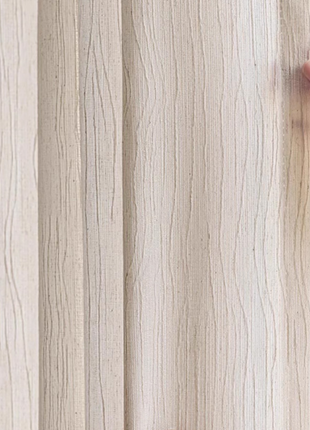 A hand is holding a curtain with a textured, wood-like appearance.