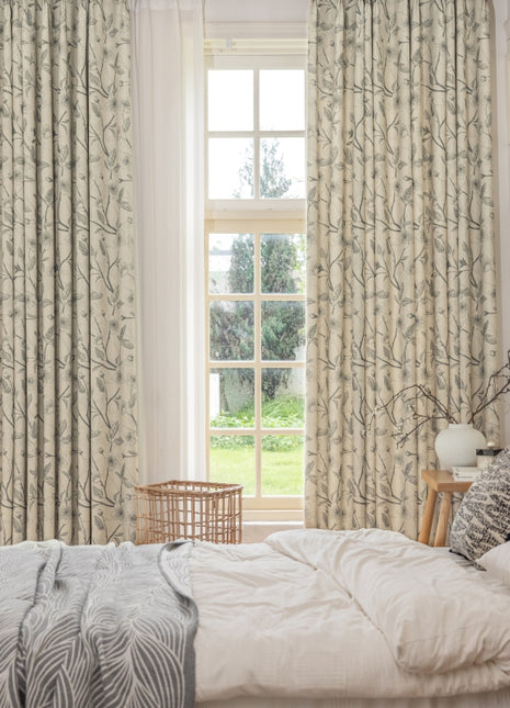 a bedroom with a bed and two windows